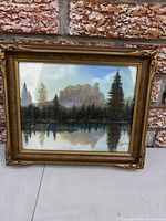 Front view of framed landscape painting showing subject and signature