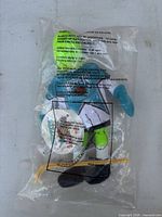 Front view of sealed Kermit NHL plush showing character face, jersey, skates inside clear bag