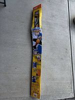 Full view of packaged yellow shark kite showing branding and dimensions