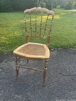 Full view of gilt wood side chair on driveway