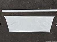 Rolled white vinyl shade with separate valance strip