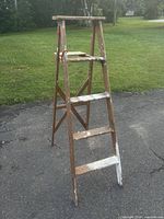 Full view of wooden 4-step A-frame ladder front