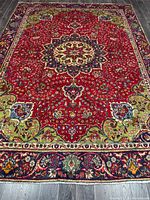 Full view of Persian Tabriz rug showing entire design and colors