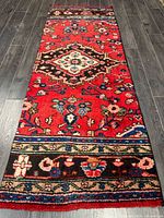 Full view of rug on floor showing complete pattern and borders