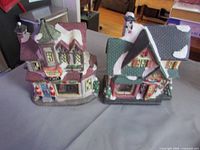 Both ceramic Christmas village buildings side by side