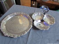 Top view of both silver-plated pieces: round tray and three-section nut dish