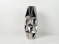 Full front view of chrome silver faceted ceramic vase