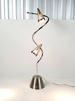 Full view of lamp showing S-curve stem, base and two cone shades illuminated