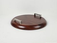 Top angle of round walnut tray showing overall design and both chrome handles