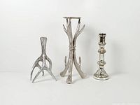 Front view of all three silver-tone candle holders