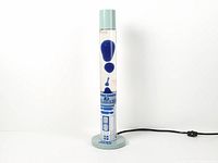Full view of illuminated R2-D2 lava lamp showing blue wax motion, power cord attached
