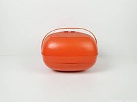 closed orange plastic carrier showing strap handle