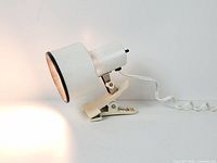 Lamp illuminated side view showing shade, clip base and light output