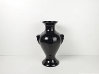 front view of black glass amphora vase showing shape and handles