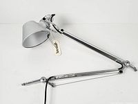 Full view of articulated lamp arm showing shade, joints, tag