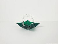 Front angled view showing green folded rim and clear twisted handle