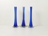 Front view of three cobalt blue frosted glass bud vases