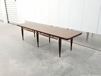 Full view of coffee table angled, showing legs and brass caps