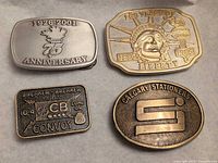 Front view of all four buckles showing designs