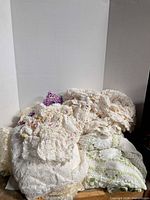 Pile of assorted crochet linens against white backdrop