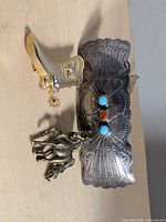 All three items grouped: barrette, boot brooch, pegasus pin