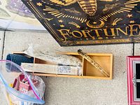 Wooden box with sage bundle, herb stick, partial fortune poster