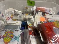 Bin containing mixed pigment and glitter packets, vials and jars