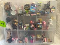 Front view of closed organizer showing multiple miniature items in compartments