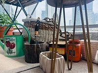 Group shot of watering can, basket, planters, plant stand