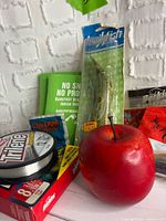 Close-up of line spool, crankbait, soft plastics and cup