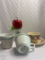 Front view of mugs, vase, cup and saucer