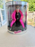 Front view of sealed 1998 Holiday Barbie in original cylindrical box