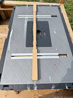 Single oak baluster displayed on work surface showing full length and turned design