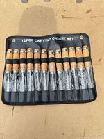 Full set of twelve chisels in pouch, plastic sleeves intact