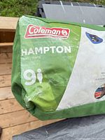 Green Coleman Hampton tent carry bag showing brand and capacity marking