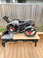 Cart folded showing all four wheels and frame