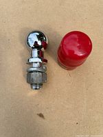 Chrome hitch ball with threaded shank, nut, washer and red cover