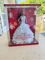 Front view of sealed 2008 Holiday Barbie in clear box showing doll and gown