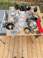 Overview of assorted plumbing parts and tool on tabletop