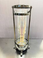 Full view of tall black metal hurricane candle holder with glass insert