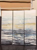 Front view of all three canvas panels forming the triptych