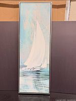 Front view of framed sailboat seascape canvas in metal frame