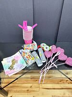 Group of cups, forks, napkins, heart picks, ribbon and banners