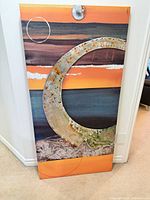 Front view of the large abstract mixed-media canvas showing painted bands and metal appliqués
