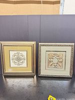 Both framed art pieces front view