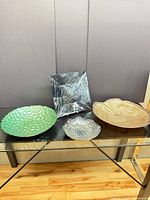 Group shot of four glass bowls on table