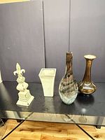 All four decorative pieces arranged on table to show form, color and scale