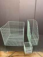Large, medium, and small mint green wire storage bins displayed side by side