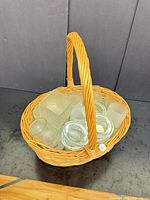 Basket containing assorted glass votive holders