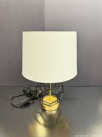 Front view of lamp showing base, shade, cord and switch